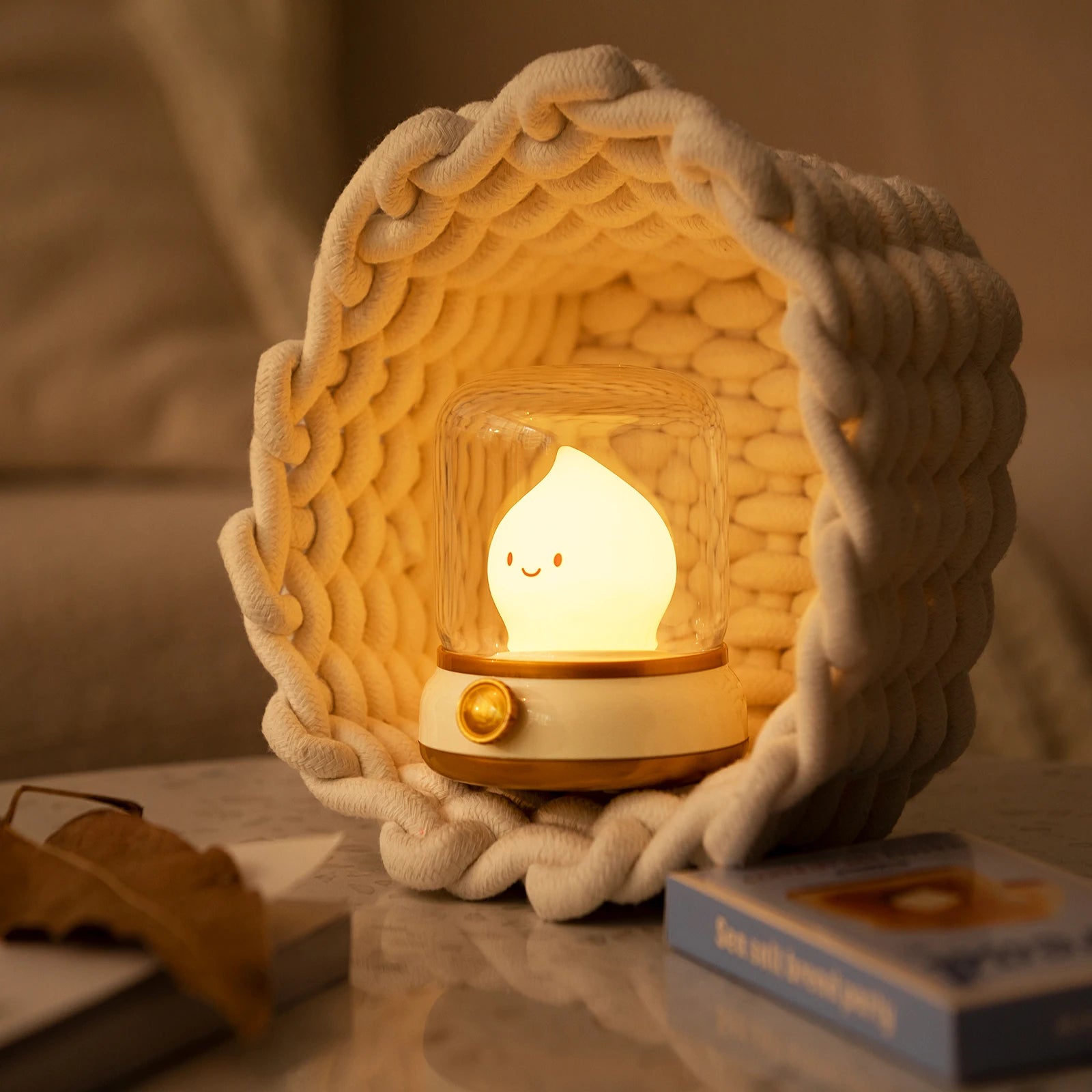 Woven basket with a glowing kawaii light bulb inside on a table