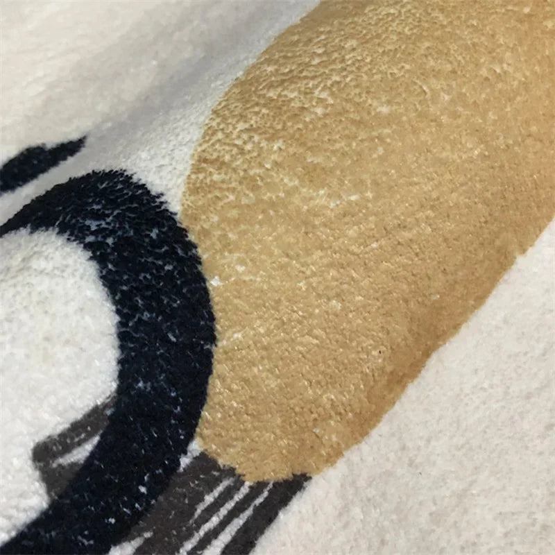 Close-up of a kawaii rug with gold, black, and white elements.