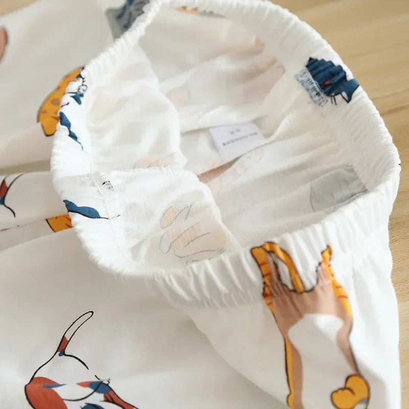 Children's outfit with kawaii cartoon design on a wooden surface