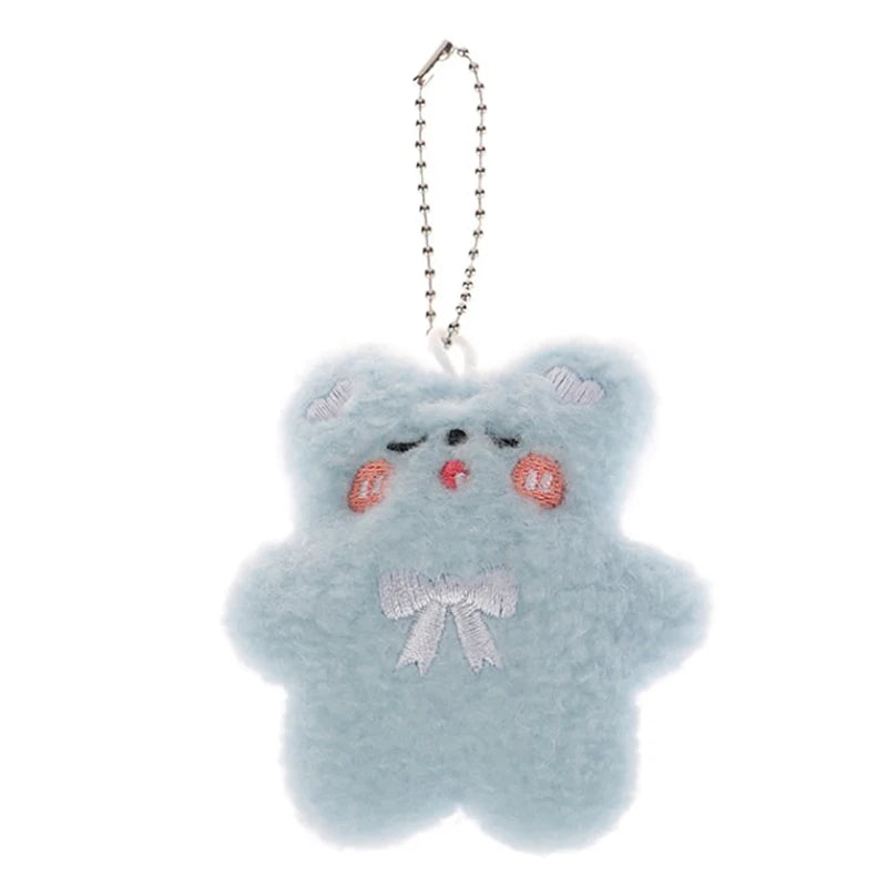 Fluffy blue kawaii keychain with a bow on a white background