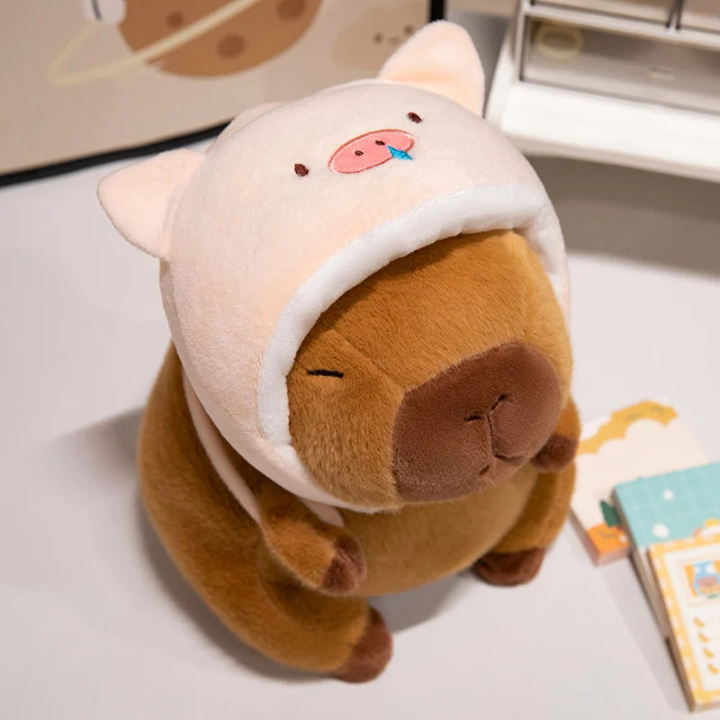 Kawaii plush toy resembling a bear with a white hood on a light surface