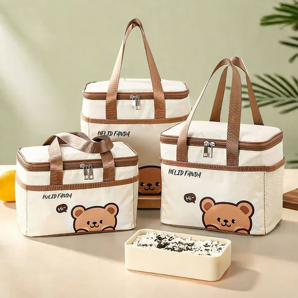 Set of insulated lunch bags with kawaii bear designs on a light background