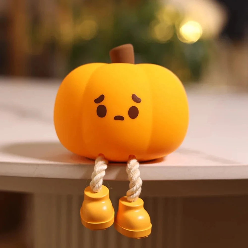 Cute kawaii pumpkin-shaped toy with a sad face on a white surface