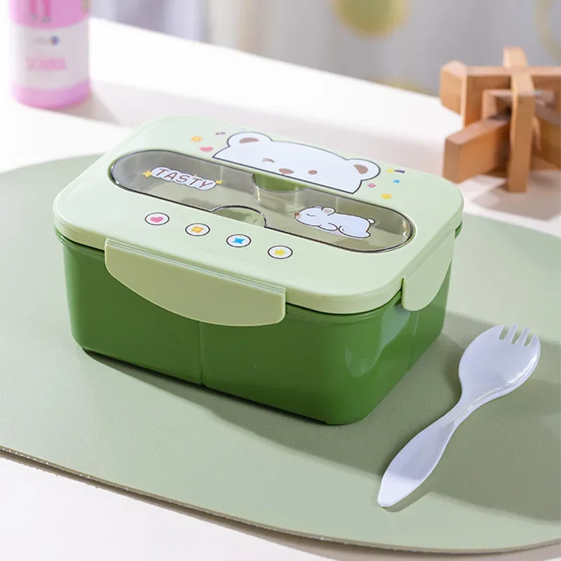 Green kawaii lunch box with cartoon design on a light green surface with a fork.