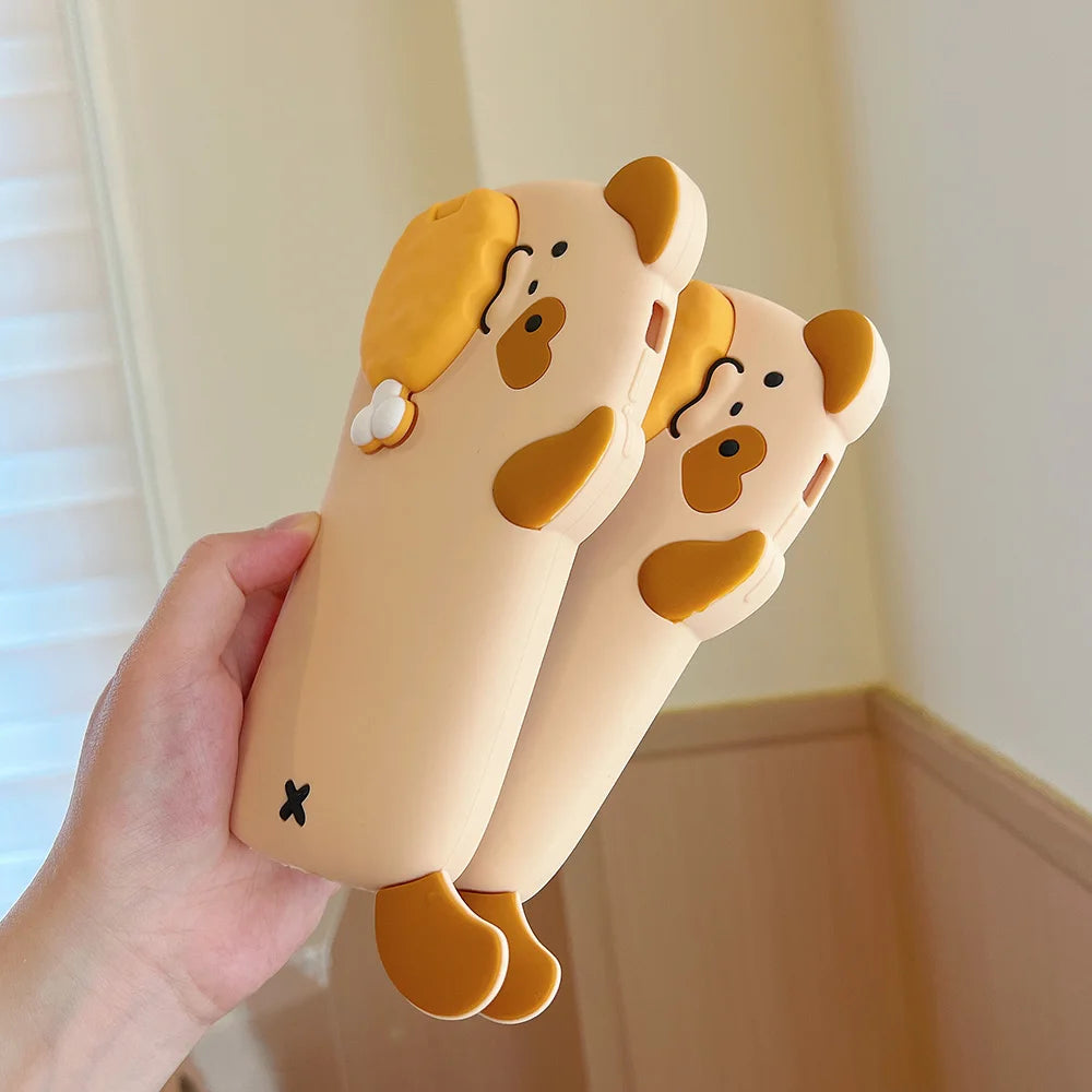 Hand holding two kawaii cartoon dog-shaped slippers against a neutral background