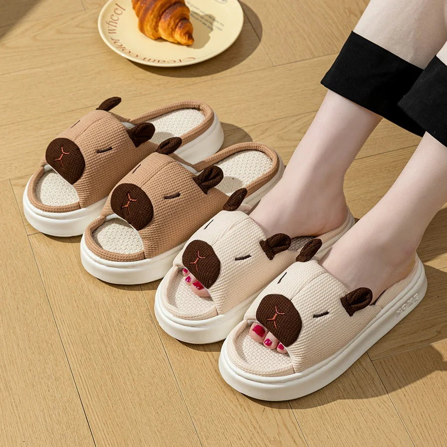Dog-themed kawaii slippers worn by a person on a wooden floor with a plate of food in the background.