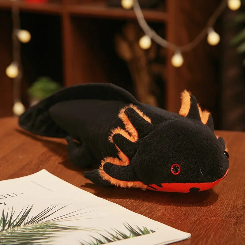 Black and orange kawaii plush toy on a wooden surface with blurred lights in the background