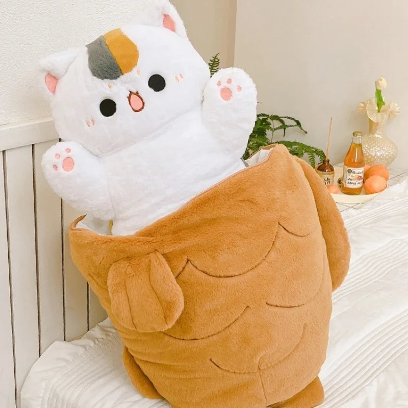 Plush toy resembling a kawaii cat in a brown bag on a bed