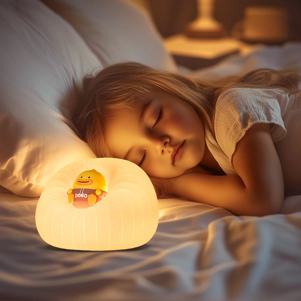 Child sleeping in bed with a glowing kawaii night light