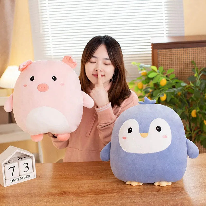 Woman holding a pink kawaii plush pig and a blue plush penguin on a wooden table.