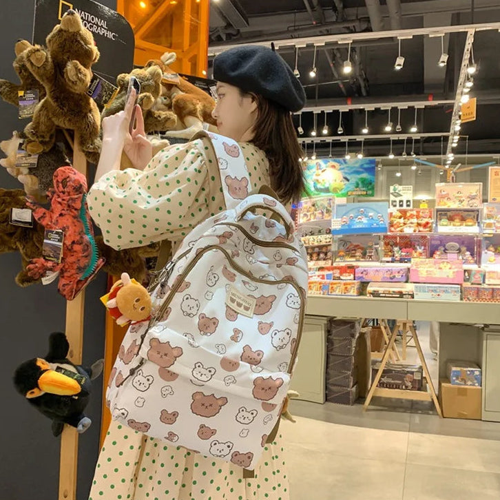 Person taking a photo of Kawaii plush toys in a store