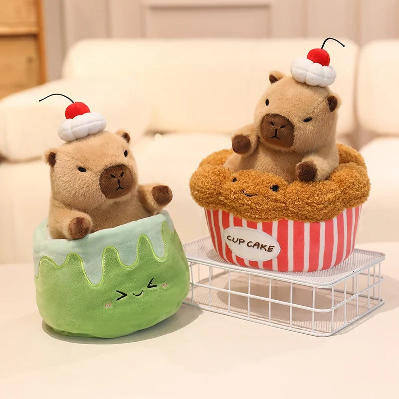 Two kawaii plush toys resembling animals in cake and cupcake shapes on a light-colored surface.