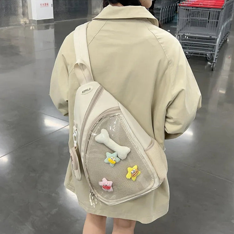 Person wearing a beige Kawaii backpack with colorful patches in an indoor setting