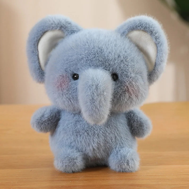 Plush elephant kawaii toy on a wooden surface with a blurred background