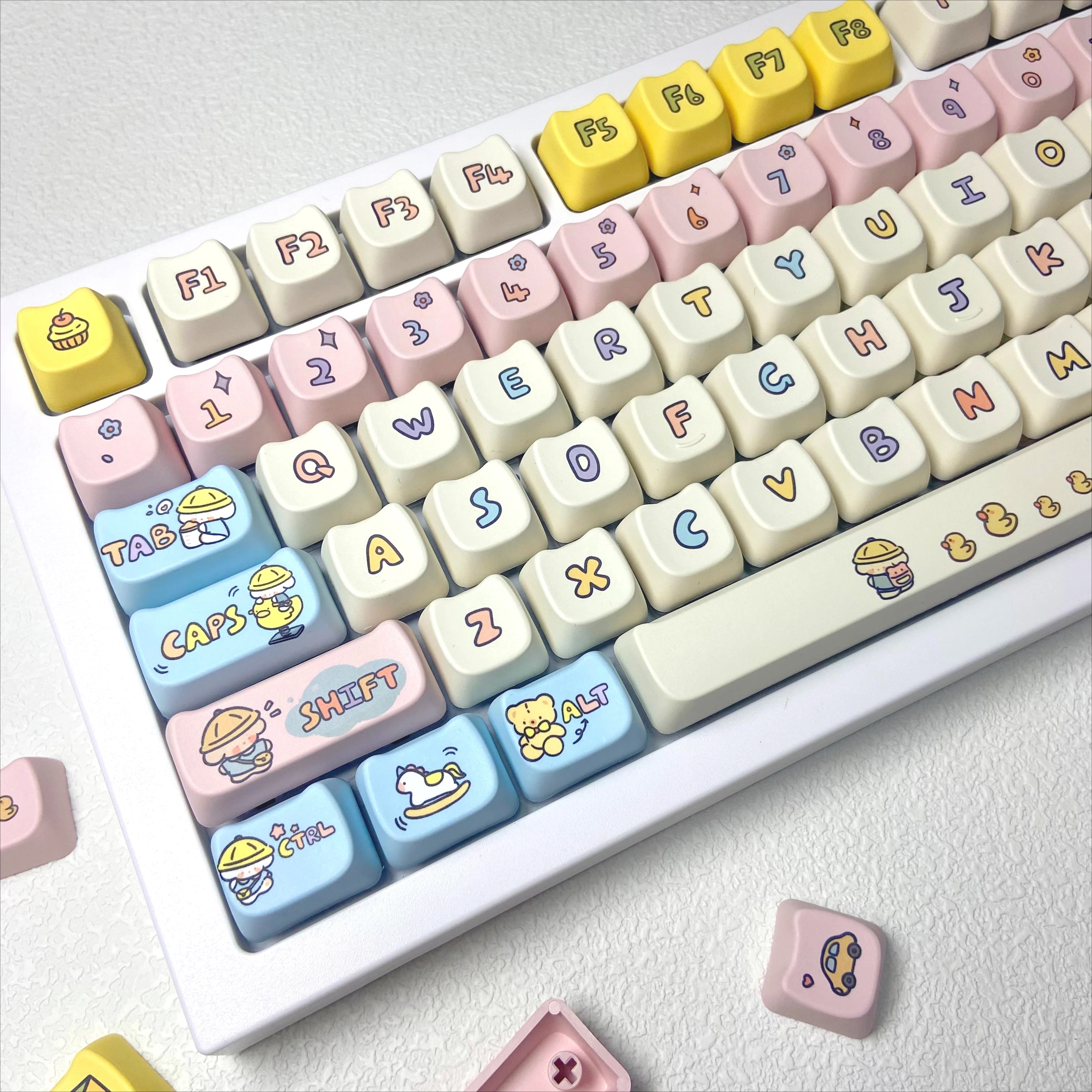Keyboard with Kawaii colorful and decorated keys on a light background
