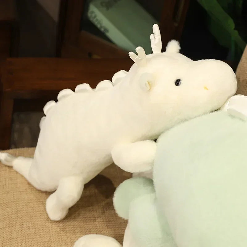 Kawaii plush toy resembling a white axolotl on a brown surface