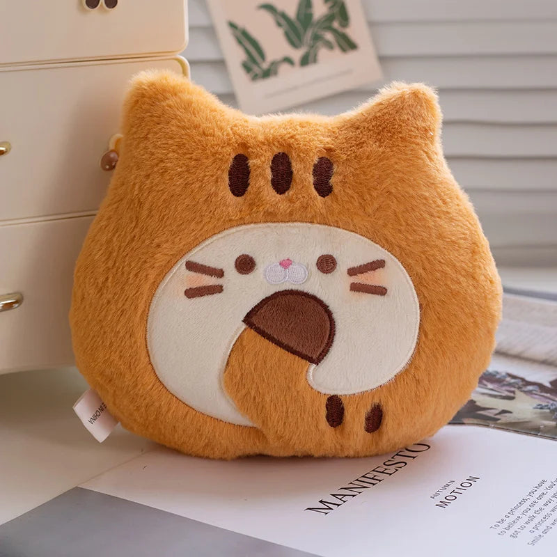 Plush toy shaped like a kawaii cat face on a surface with a blurred background