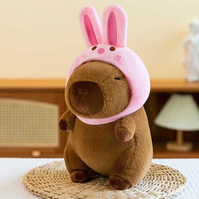Kawaii plush toy with a pink bunny headband on a woven mat