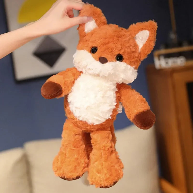 Plush fox kawaii toy held by a hand with a blurred indoor background