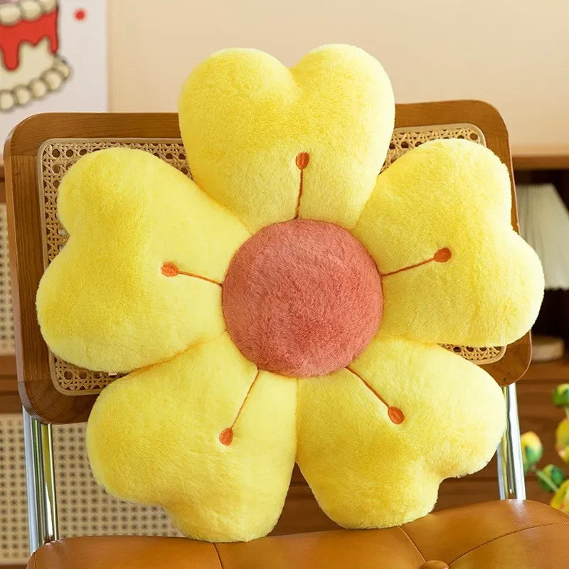 Yellow flower-shaped kawaii pillow on a chair with a blurred background