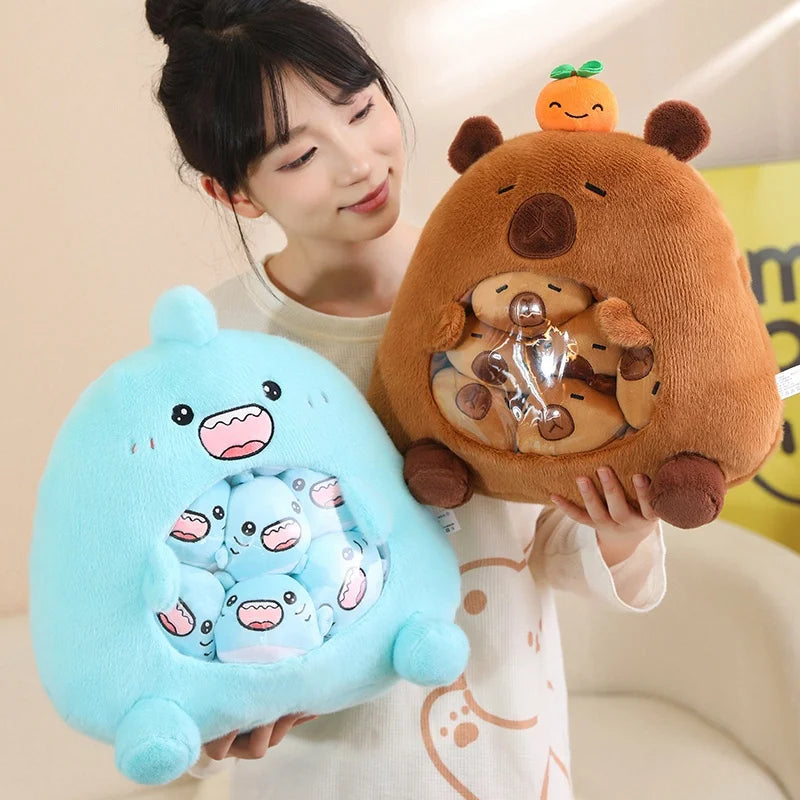 Person holding two kawaii plush toys, one blue and one brown, against a neutral background.