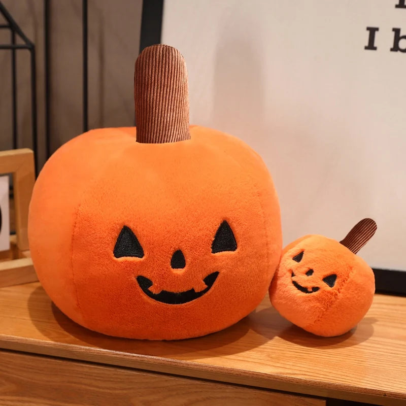 Two kawaii plush pumpkins with smiling faces on a wooden surface.