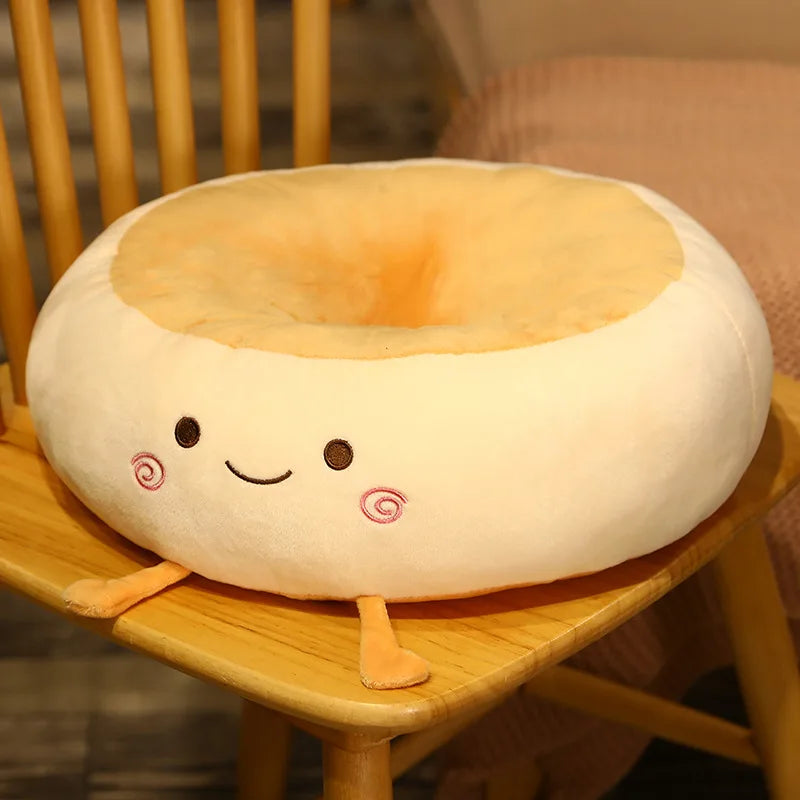 Plush donut-shaped kawaii cushion with a face on a wooden chair