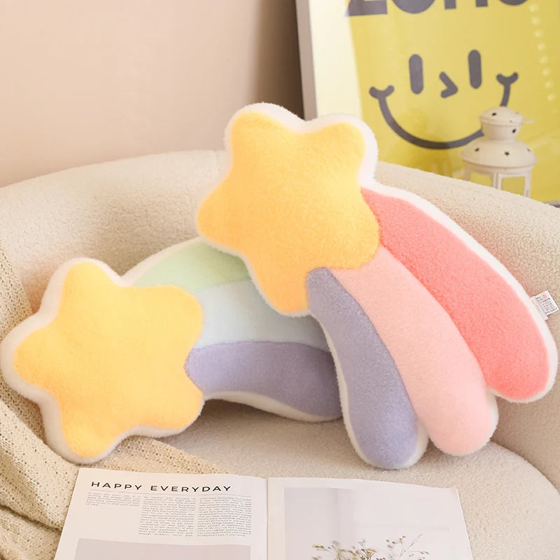 Colorful star-shaped kawaii pillow on a couch with a smiley face pillow in the background.