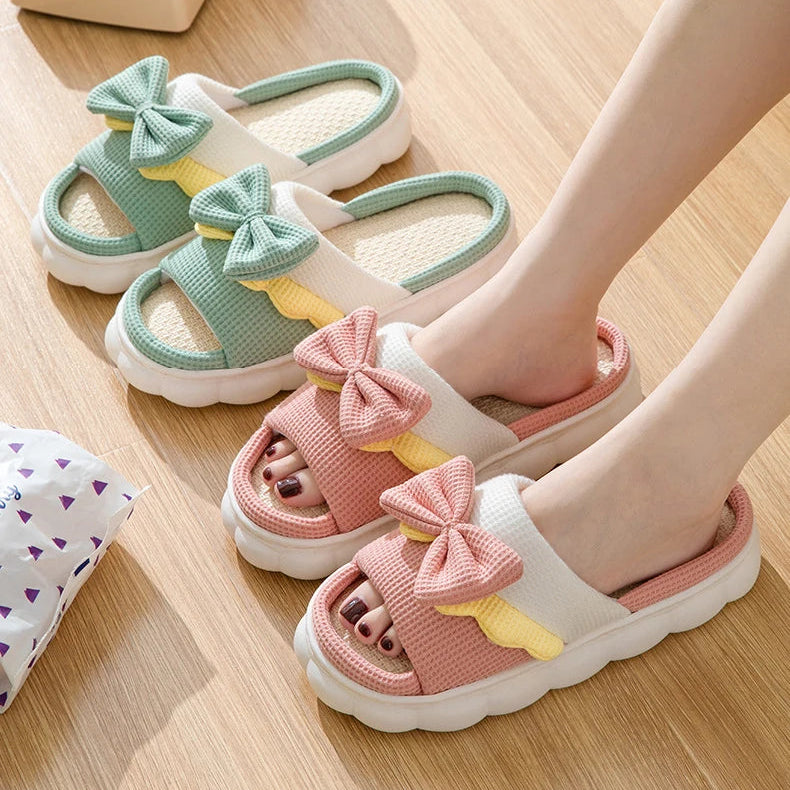 Children's sandals with kawaii bow details on a wooden floor