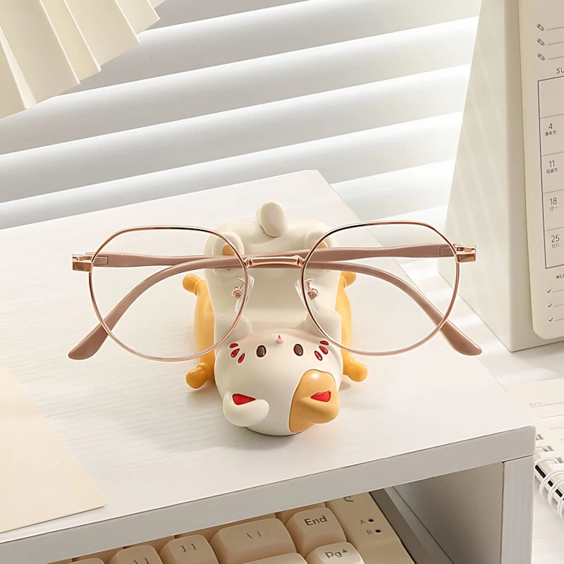 Glasses kawaii holder shaped like a cartoon cow with glasses on a desk.