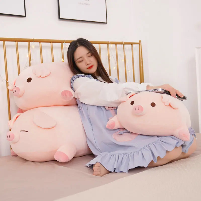 Woman sitting on a bed with large pink pig-shaped kawaii cushions