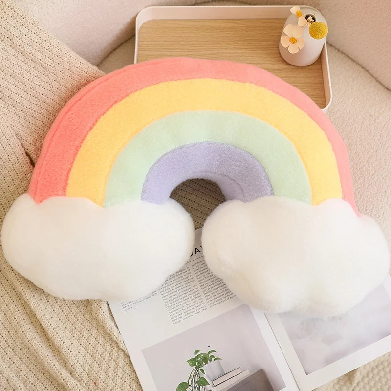 Rainbow-shaped kawaii cushion with cloud ends on a couch