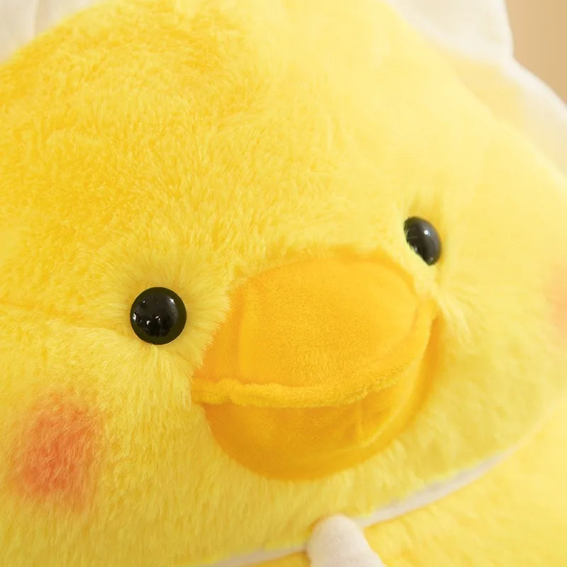 Close-up of a yellow kawaii plush duck toy with black eyes and a red spot on its cheek.