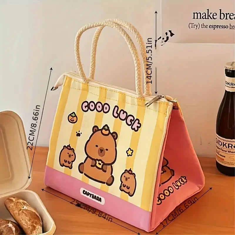 Cartoon kawaii bear-themed tote bag with 'Good Luck' text on a wooden surface, next to a bottle of beer.