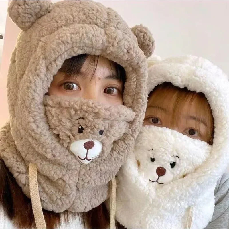 Two people wearing Kawaii bear-themed hooded scarves with cartoon faces.