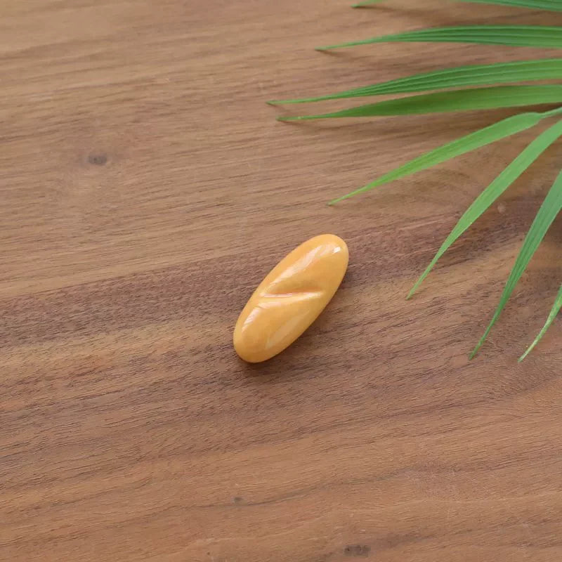 Kawaii yellow pill on a wooden surface with green leaves