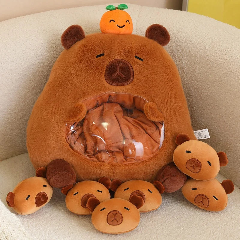 Kawaii plush bear toy with small bear figures and a smiling orange on a beige surface