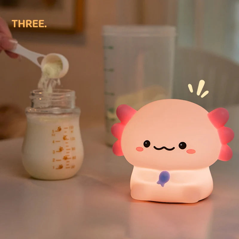 Baby bottle with milk being poured and a kawaii  lamp with a face on a table.