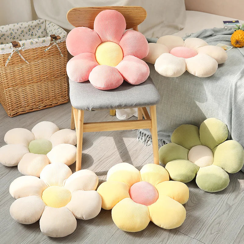 Flower-shaped Kawaii cushions in various colors on a wooden floor with a chair and basket in the background.