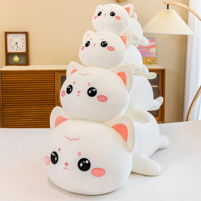 Stack of cute kawaii plush cat toys on a light surface with a neutral background