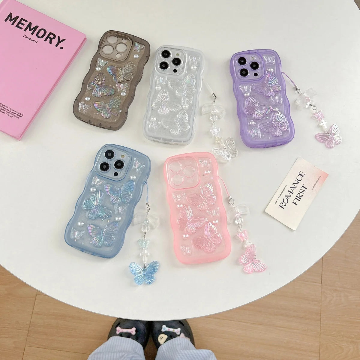 Five kawaii phone cases with butterfly designs on a round white table.