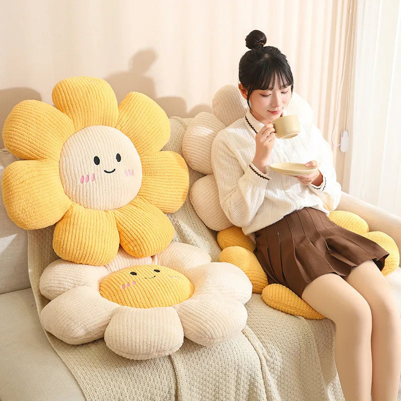 Woman sitting on a couch with sunflower-shaped kawaii cushions and a smiling face.