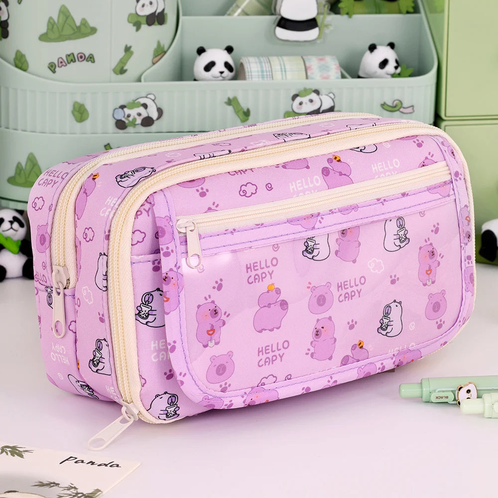 Pink pencil case with kawaii cartoon character pattern on a white surface