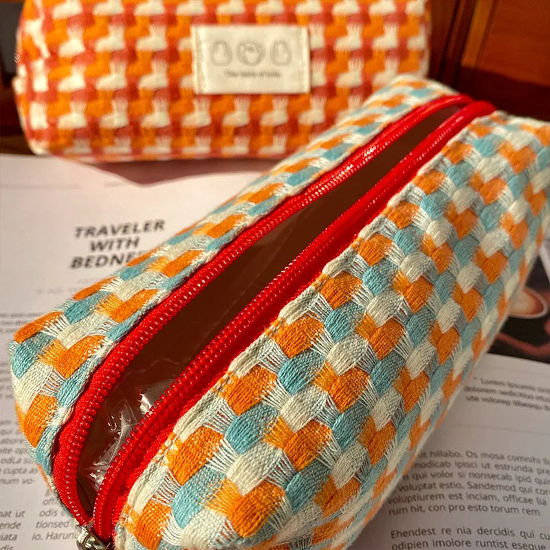 Woven kawaii pouch with red zipper on a magazine background