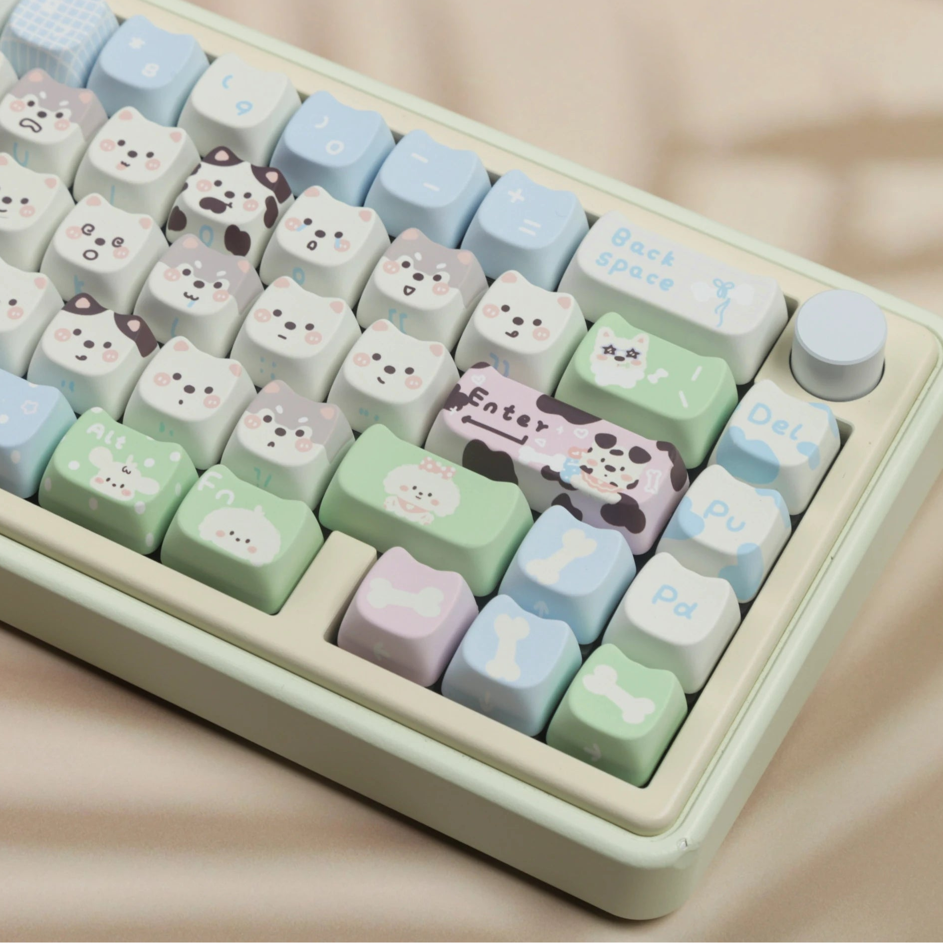 Keyboard with cute kawaii animal-themed keys on a beige background