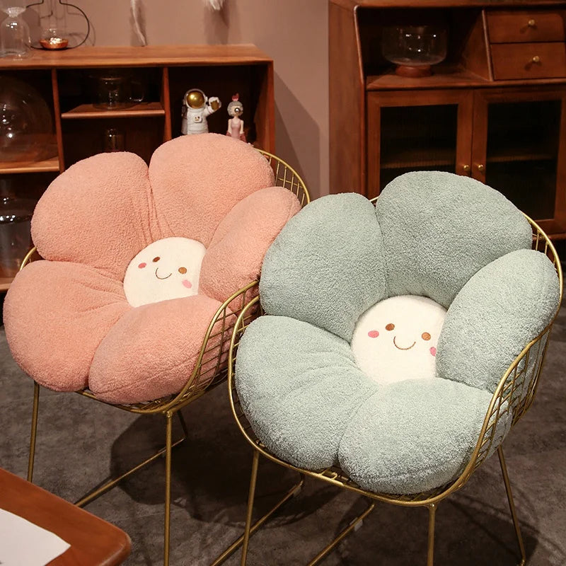 Two flower-shaped kawaii cushions with smiling faces on gold frames in a room setting.