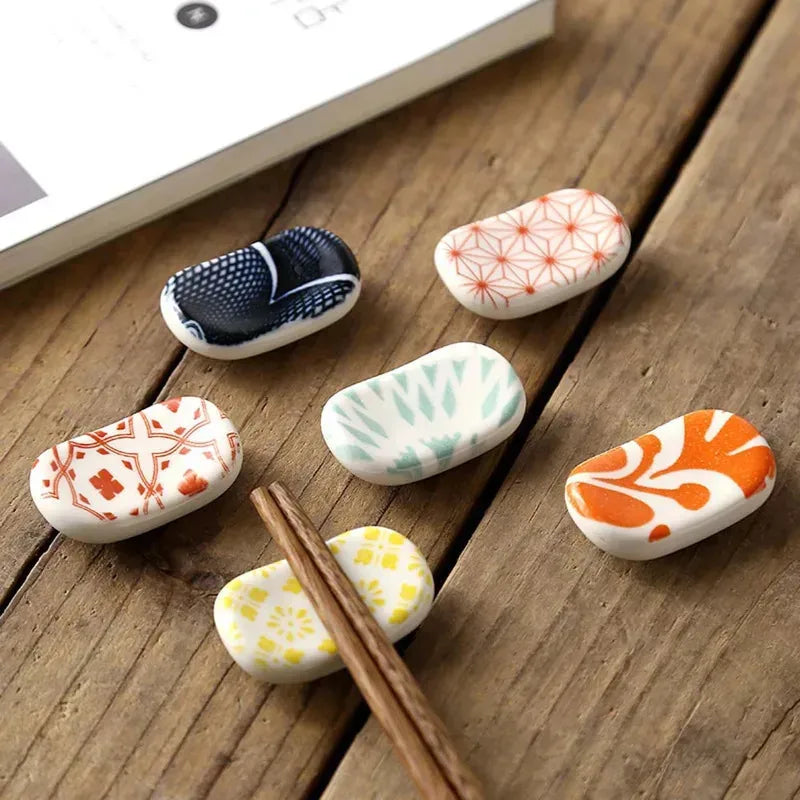 Decorative ceramic stones with kawaii floral patterns on a wooden surface