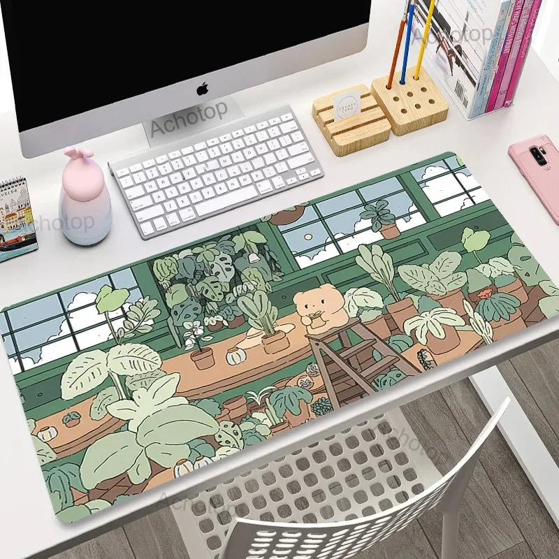 Desk setup with a decorative mouse pad featuring a Kawaii bear and plants design.