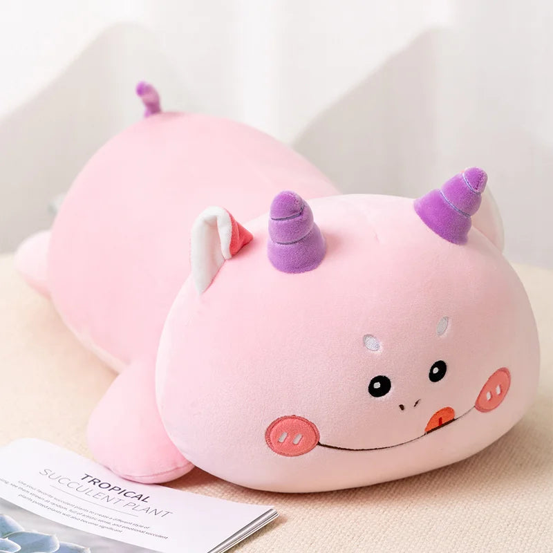 Pink kawaii plush toy with a unicorn design on a light background