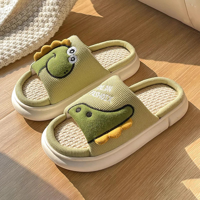 Pair of green kawaii dinosaur slippers on a wooden floor